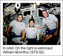 In orbit. On the right is astronaut William McArthur (STS-92) (Courtesy of NASA)