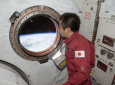 Astronaut Wakata viewing Earth. Telemedicine experiment data was successfully transmitted to Earth (Courtesy of NASA)