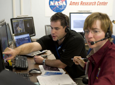 Dr. Anthony Colaprete and a colleague reviewing the initial data from LCROSS (Courtesy of Dominic Hart / NASA Ames)
