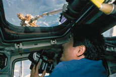 Astronaut Doi taking photos of the release of the Spartan spacecraft during the STS-123 mission. (Photo by NASA)