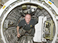 Astronaut Fincke working in the Kibo airlock (Courtesy of NASA)
