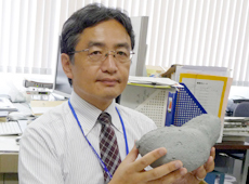 Dr. Yoshikawa with a model of asteroid Itokawa