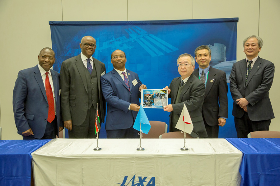 Officials from Kenya receiving the handover acknowledgement from JAXA Officials