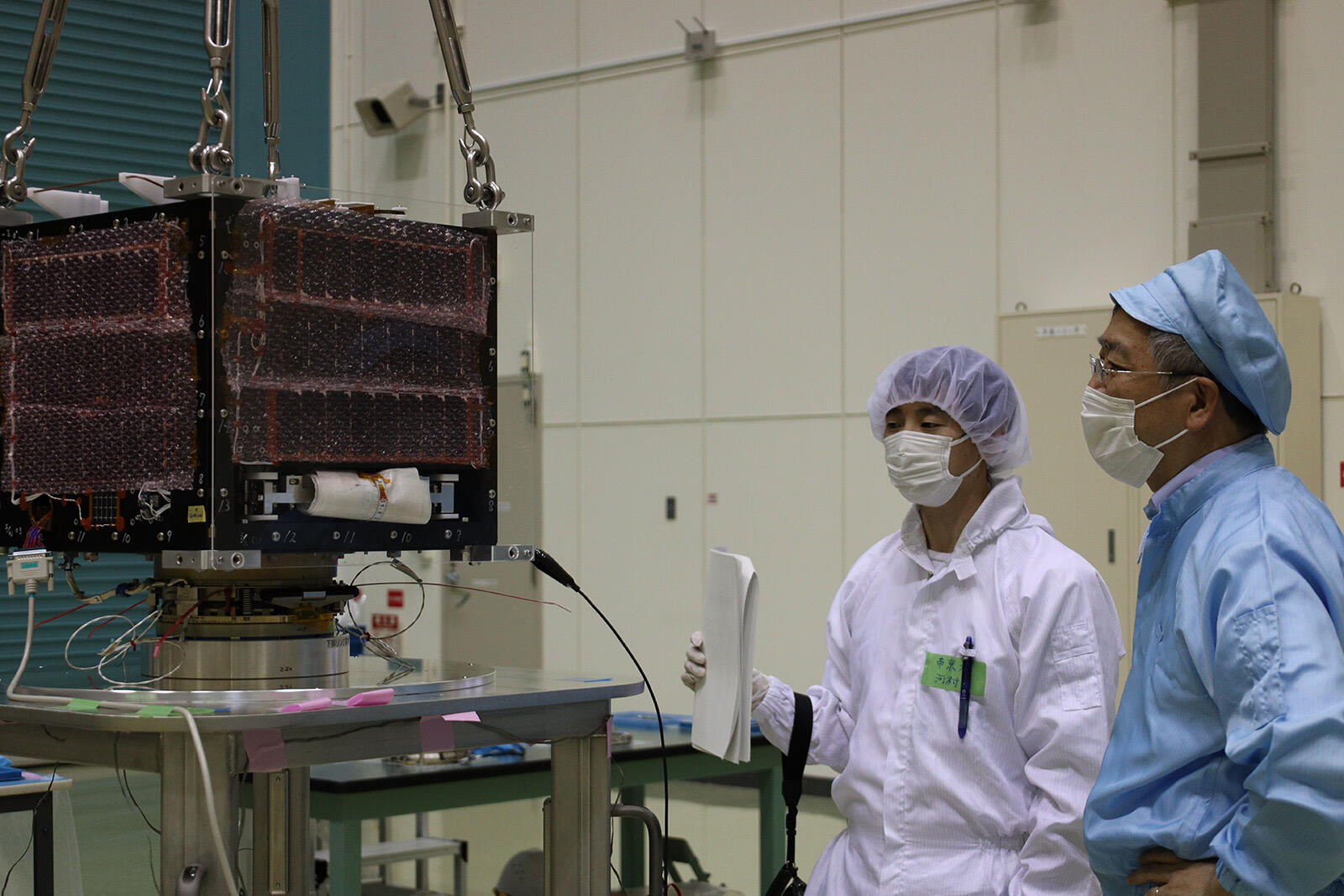 Group Head Kaneko attending the test on TeikyoSat-4, which is one of the microsatellites to be launched in Innovative Satellite Technology Demonstration-2 (right person in the photo)