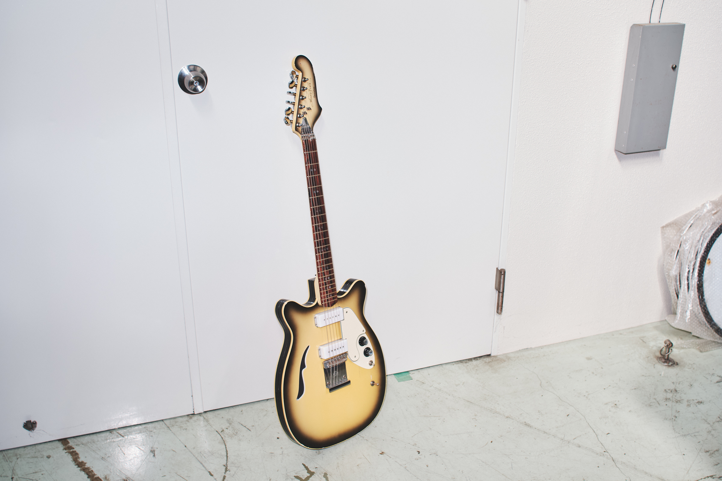 The electric guitar is a 1970s Micro-Frets Spacetone
