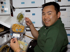Astronaut Hoshide having a meal on his previous space mission (courtesy: NASA)