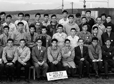 Group photo taken at a rocket motor static firing test in 1962. Hideo Itokawa and Ryojiro Akiba are sitting in the center of the front row.