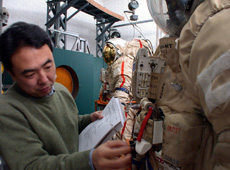 Astronaut Furukawa taking part in a lecture about the Russian Extravehicular Activity suit at an early stage of Soyuz spacecraft study.