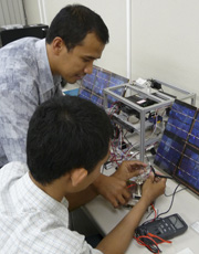 Studying a small-scale satellite system at JAXA.