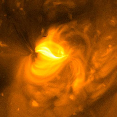 Corona above a solar active region. The dark spot on the top left is a plasma flow emanating outward.