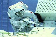 Astronaut Satoshi Furukawa participating in a technology development test for an extra-vehicular activity.