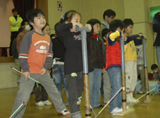 Children launching straw rockets