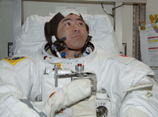Astronaut Akihiko Hoshide trying on a spacesuit. The suit was handmade. (courtesy: JAXA/NASA)
