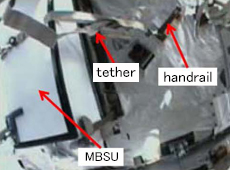 MBSU tethered to the ISS handrail (courtesy: JAXA/NASA)