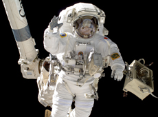 Astronaut Hoshide being carried on the ISS robotic arm (courtesy: JAXA/NASA)