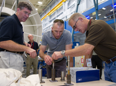 Technicians and astronauts meet to consider how to mount a bolt. (courtesy: NASA)