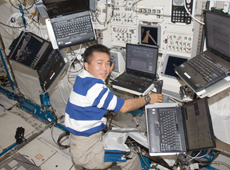 Astronaut Wakata working at Kibo's robotic arm console (Courtesy of NASA)