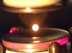Hot sample being levitated in the Electrostatics Levitation Furnace