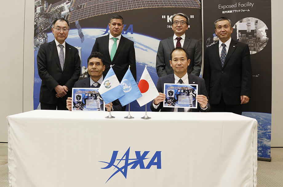 Officials from Guatemala receiving the handover acknowledgement from JAXA Officials